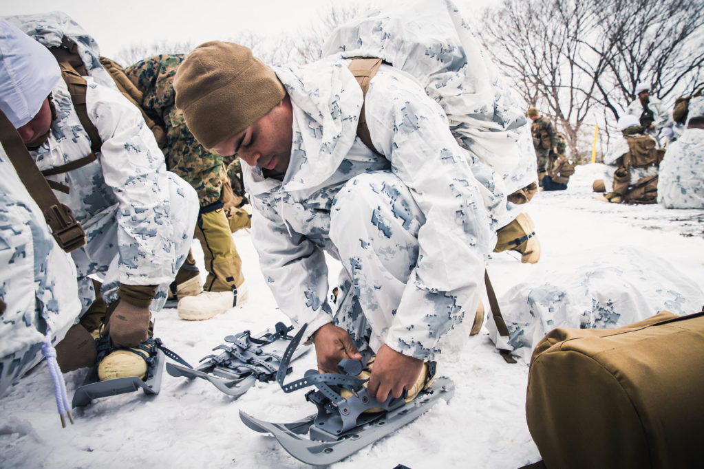 U.S. Marine Corps Lance Cpl. Brian Rubenacker adjusts his snow shoes during Exercise Forest Light on Camp Sendai, Sendai, Japan, Feb. 17, 2018. Marines conducted practical application using the extreme cold weather system. Rubenacker, a Farmdale, New York native, is a rifleman for Golf Company, 2nd Battalion, 1st Marine Regiment, 3rd Marine Division. (U.S. Marine Corps photo by Lance Cpl. Damion Hatch Jr.)