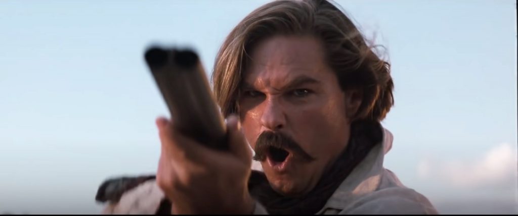 Kurt Russell as Wyatt Earp with a shotgun.