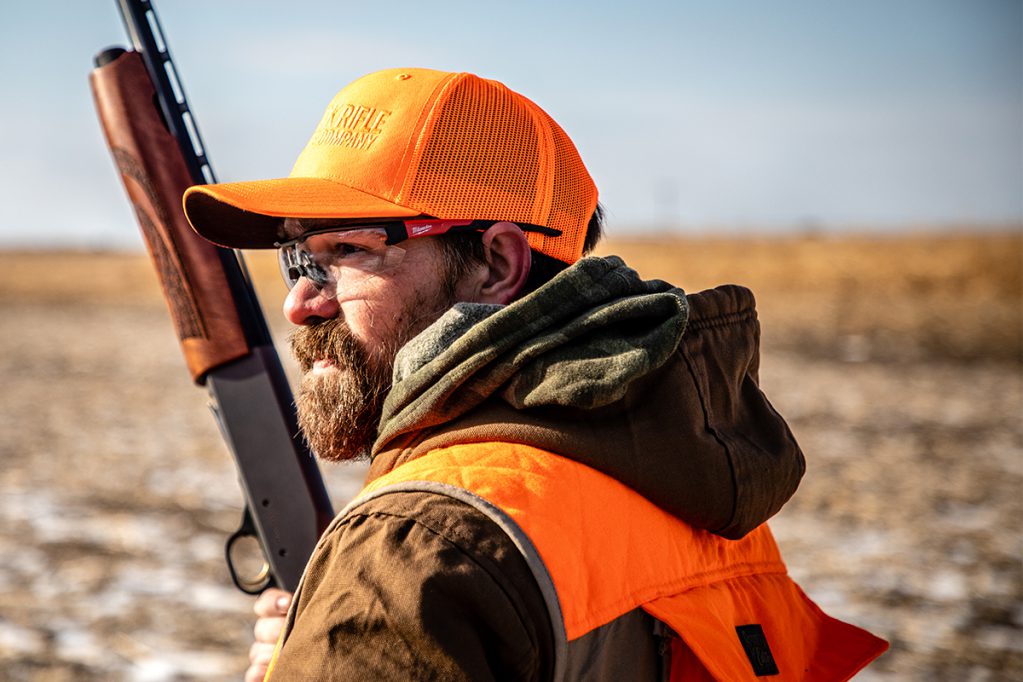 hunter with shotgun wearing blaze orange
