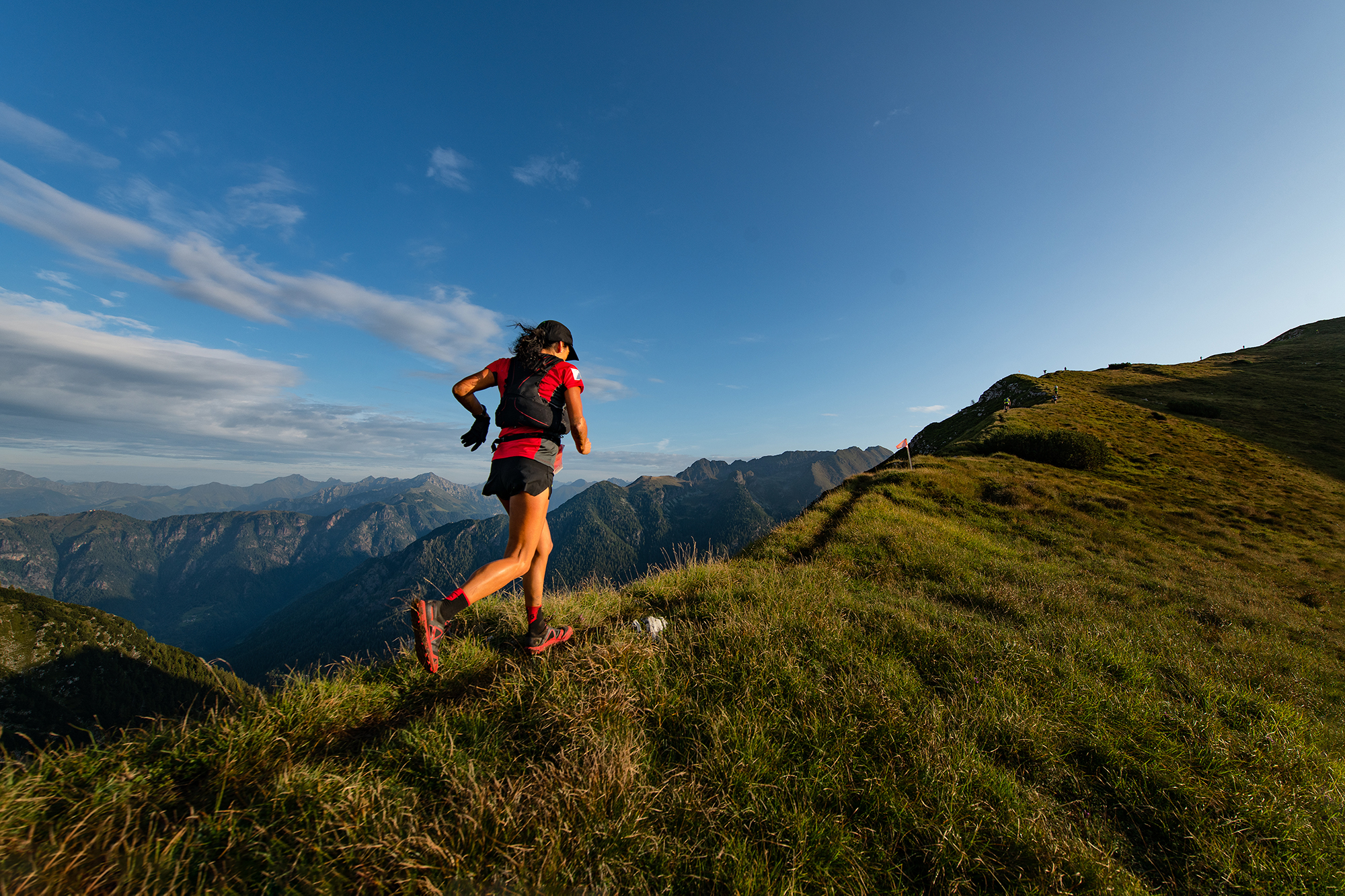 woman runs mountain trail