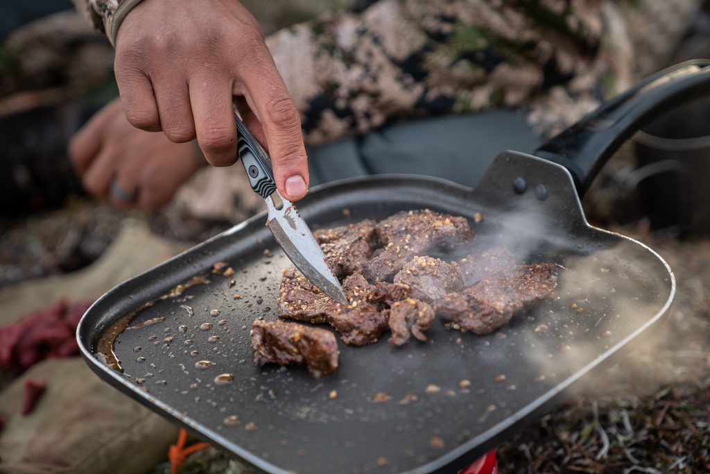 cooking caribou meat in camp