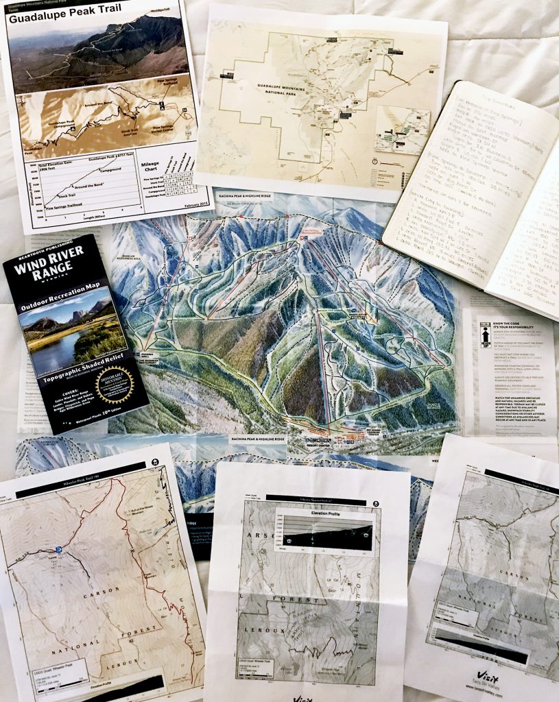 trip planning materials laid out for planning an outdoor trip