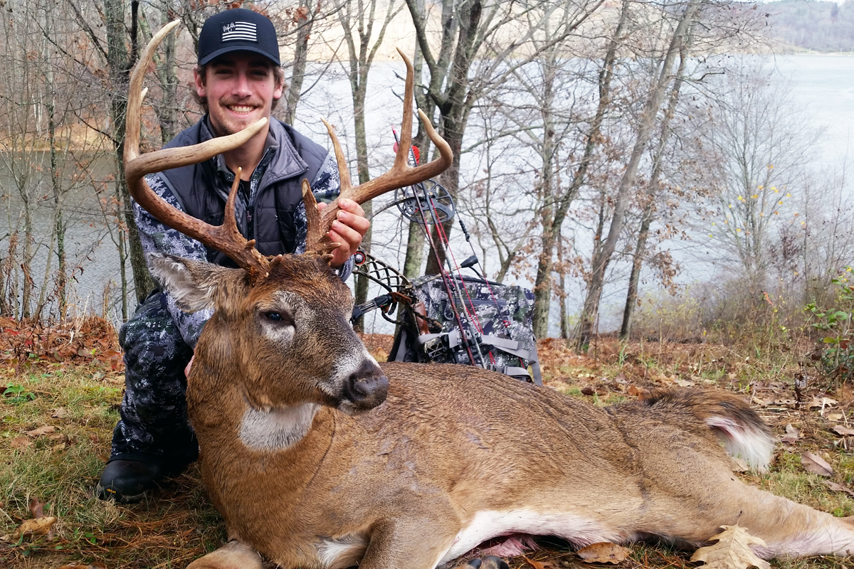 man with whitetail buck