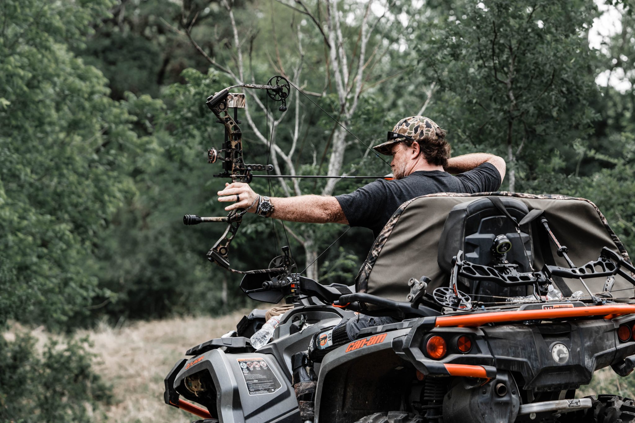 Clint Trial shooting a bow from his ATV