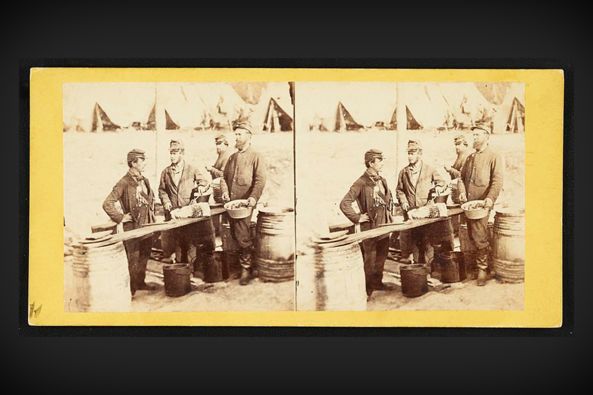 Soldiers prepare a meal in a makeshift kitchen during the Civil War.
