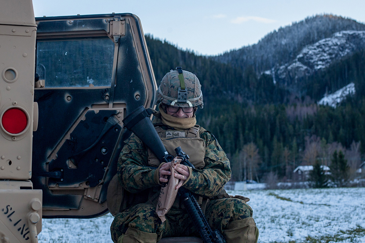 Lance Cpl. William Evans, a Marine with 2nd Marine Logistics Group-Forward, opens an MRE near Voll, Norway, Oct. 29, 2018.